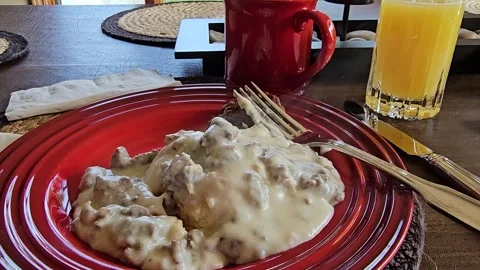Steaming savory biscuits and gravy breakfast meal plate Stock Footage 336149906