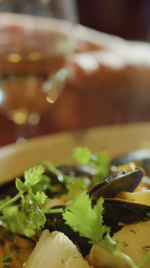 Steaming Seafood Chowder and White Wine in Cozy Restaurant Stock Footage 314868882