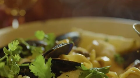 Steaming Seafood Chowder Served with Fresh Herbs and Wine Stock Footage 314820185