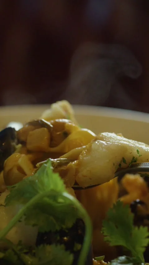 Steaming Seafood Chowder Served with Spoon in Close-Up Stock Footage 314706762