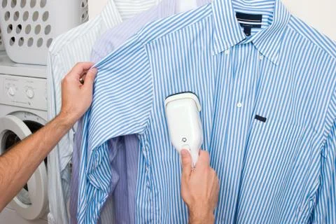 Steaming a shirt Stock Photos