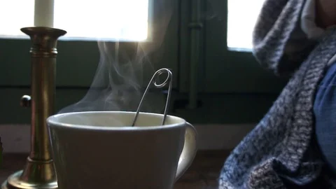 Steaming Tea Cup With A Lit Candle Near Window In France Stock Footage 97126816