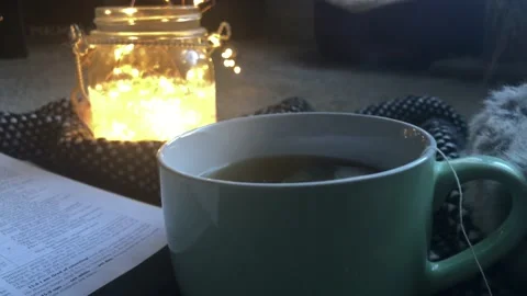 Steaming Tea Next to Open Bible Vídeo Stock 100696778