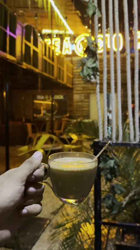 Steaming Tea in the Rain at a Neon-Lit Outdoor Café Stock Footage 326801522
