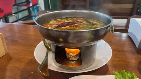Steaming Tom Yum Hot Pot with Alcohol Burner Flame Stock Footage 338045075