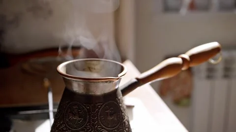 Steaming Traditional Copper Coffee Pot On Stove In Morning Light Stock Footage 330118087