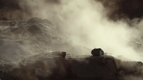 Steaming volcanic gas clouds blowing over Owakudani Hell Valley black Stock Footage 104833337