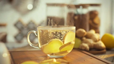 Steaming water flows over dried chopped brown root in a bright kitchen unlea Stock Footage 331361932