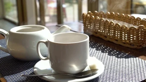 Steaming white cup mug of tea coffee on the table in cafe. Hot beverage Stock Footage 80789819