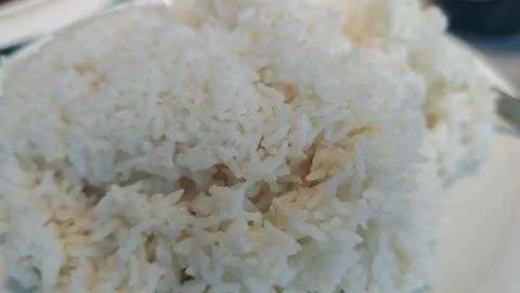 Steaming white rice served on a round plate with a side of colorful vegetab.. Stock Photos