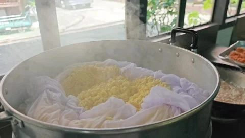 Steaming yellow split mung beans with cheesecloth in a metal steamer. Stock-Footage 346532969