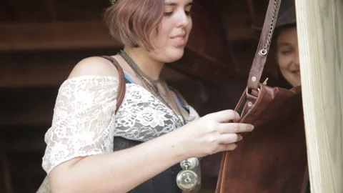 Steampunk Customer Inspects Leather Bag at Market Stock Footage 345279003