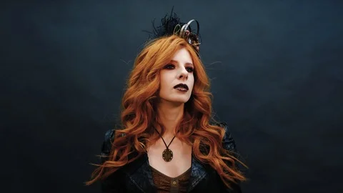 Steampunk gothic girl poses for the camera in slow-mo shooting Stock Footage 126525437