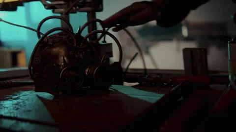 Steampunk Mask laying on the table and picked up by a man Video stock 259855993