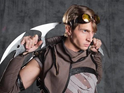 Steampunk or post-apocalyptic style character, with an unusual cold weapon Stock Photos