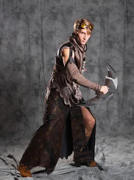 Steampunk or post-apocalyptic style character, with an unusual cold weapon Stock Photos