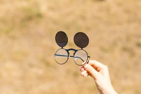 Steampunk sunglasses model held in hand with round lenses retro flip up model Stock Photos