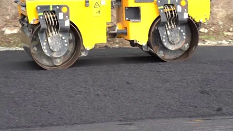 Steamroller compact flatten out the asphalt tar Stock Footage 138137257