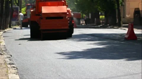 A steamroller rolls and compresses hot asphalt. Stock Footage 11459429