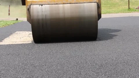 Steamroller rolls on pavement Stock Footage 146609973