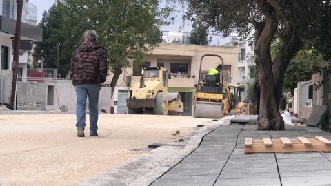 Steamroller's Working on Road Construction in Populated area Stock Footage 122946629