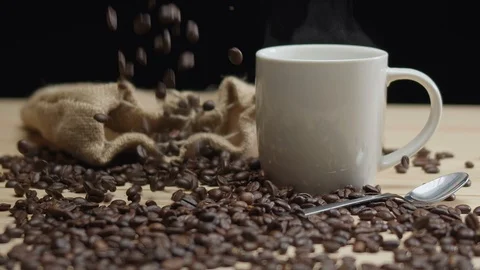 Steamy Cup of Coffee Seeds Falling Stock Footage 123687739