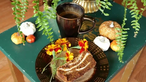 Steamy Cup of Pumpkin Spice Latte Sitting on a Table with a Slice of Bread 4K Video stock 317312047