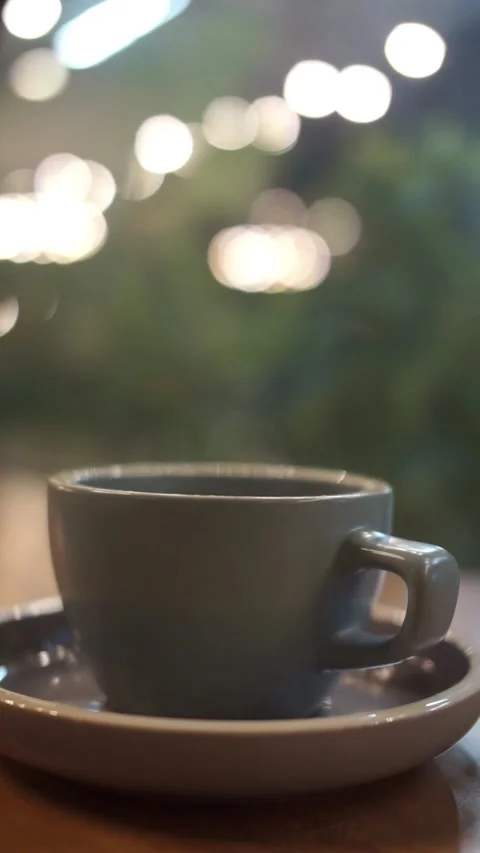 Steamy hot a cup of coffee on the table Stock Footage 310747601