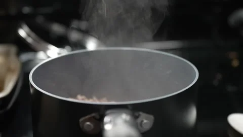 Steamy pot on stove Stock Footage 243399192