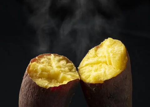 A steamy sweet potato split in half Stock Photos