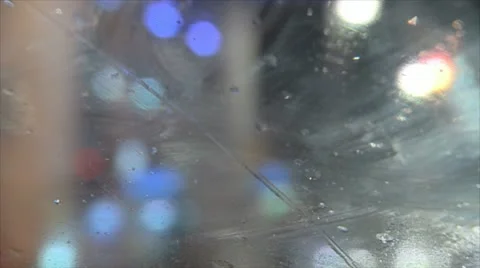 Steamy windshield shot in heavy rain from a taxi cars out of focus Stock Footage 12701482