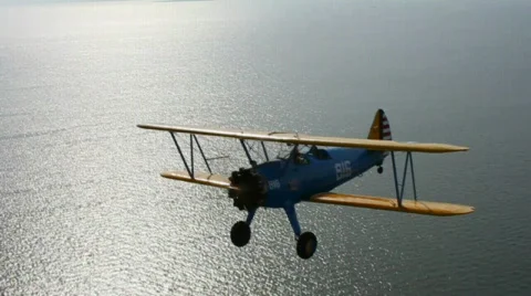 Stearman Flies Over Ocean Stock Footage 731718