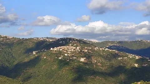 Stedy Shot of Village in a mountain with clouds moving Stock Footage 266397762