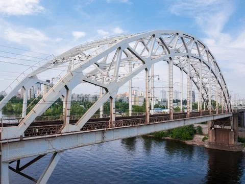 Steel arch truss of the railroad bridge across the river Stock Photos