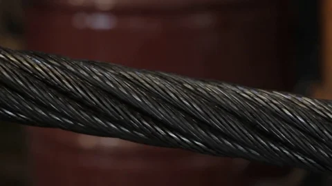 Steel cable fed into machine Stock Footage
