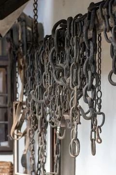 Steel chains hung on the wall for working with horses 스톡 사진