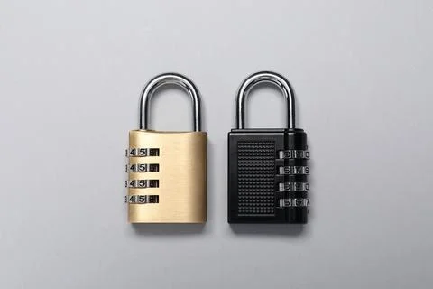 Steel combination padlocks on grey background, top view Stock Photos
