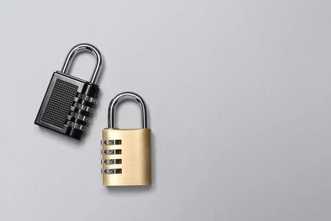 Steel combination padlocks on grey background, top view. Space for text Stock Photos