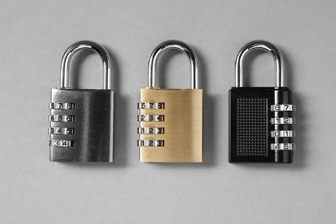 Steel combination padlocks on grey background, top view Stock Photos
