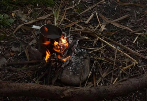 Steel cup with cofee cooking on fire Stock Photos