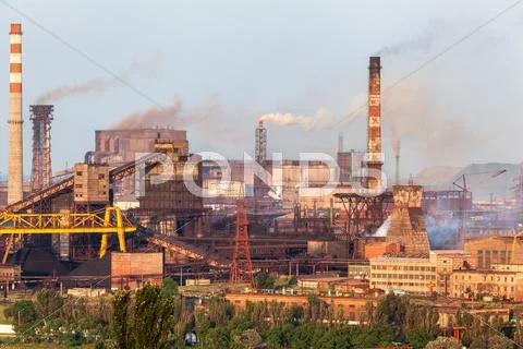 Steel Factory With Smokestacks At Sunset. Metallurgical Plant. Steelworks