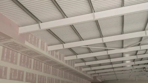 Steel frame building construction interior view metal roof purlins corrugat.. Fotos Stock