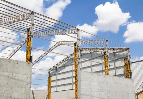 Steel frame structure building at construction site Stock Photos