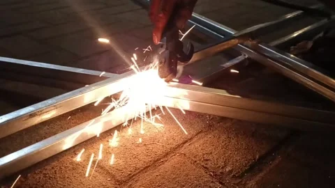 Steel frame welding at night producing bright sparks and blue arc light on p 스톡 동영상 344087393