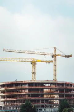Steel Frames of A Building Under Construction, With Two Tower Cranes On Top Stock Photos
