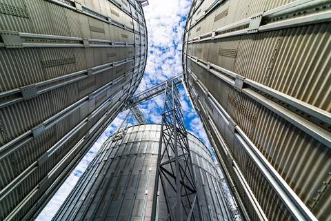 Steel grain elevators. Modern up to date factory. Selective focus. View from  Stock Photos