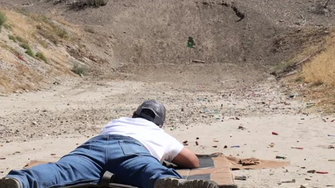 Steel Hostage reactive target is hit by prone shooter with bolt action rifle Video stock 249019907