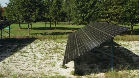 Steel mounting racks support ground mounted solar panel array to generate power Video stock 346281229