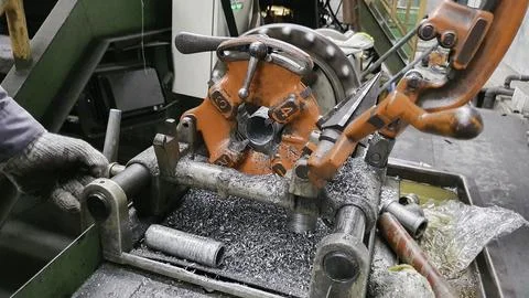 Steel pipe cutting and threading machine for plumbing work in factory, metal  Stock Photos