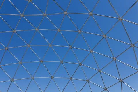 Steel polygon frame shell structure against blue sky Stock Photos